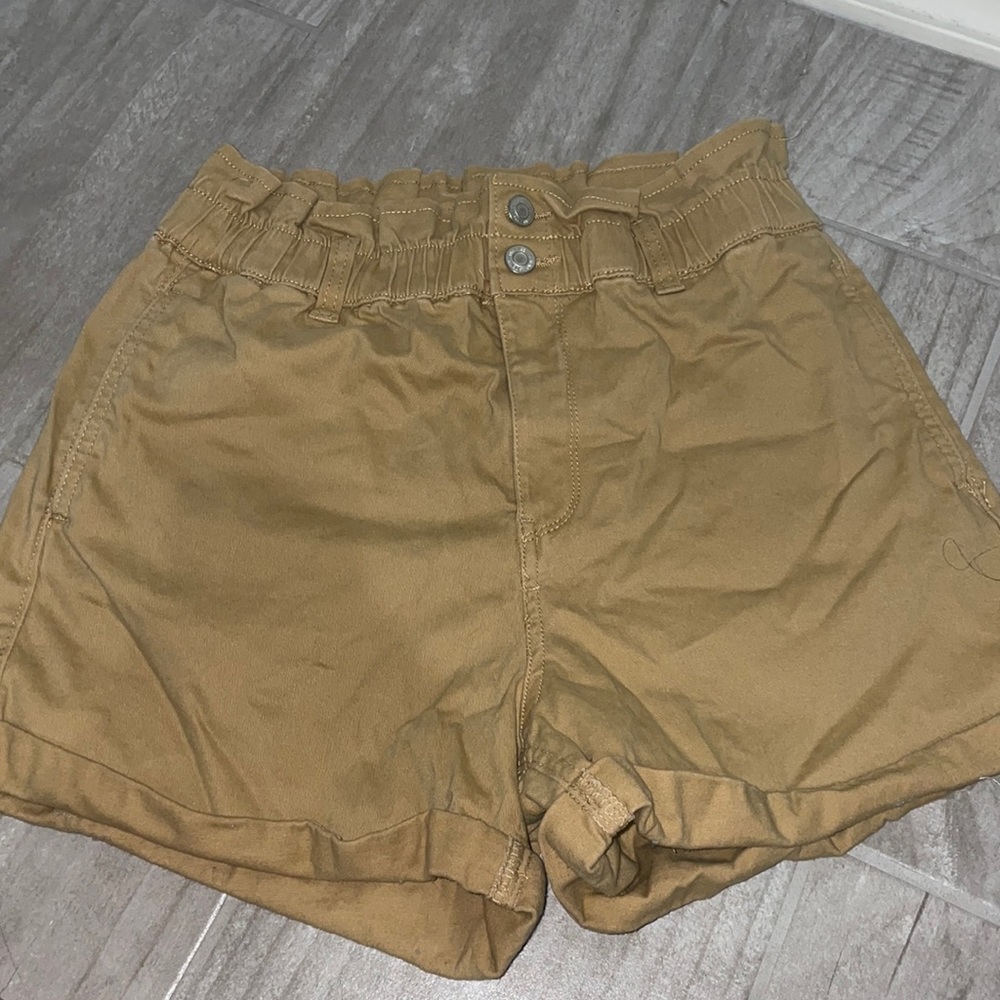 High waisted tan shorts.